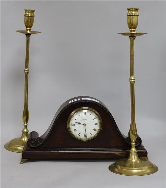 A mantel clock and a pair of brass candlesticks